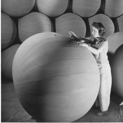 Woman worker applying the finishing touches to a flotation bag used to support airplanes forced down at sea