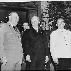 British Prime Minister Winston Churchill (left), President Harry S. Truman, and Soviet leader Josef Stalin on the steps of Mr. Churchill
