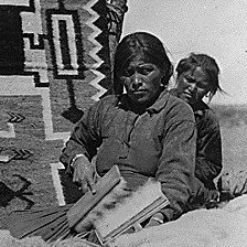 Carding wool to be used in Navajo Indian rug weaving. Southern Navajo Agency