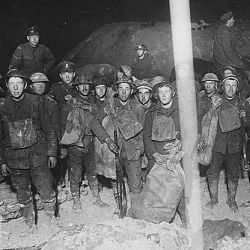 These Tommies are in the trenches at St. Quentin getting their provisions which were brought up in limbers at night