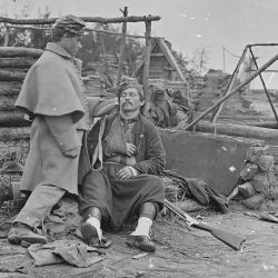 Scene showing deserted camp and wounded soldier. (Zouave)