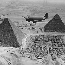 An Air Transport Command Plane Flies over the Pyramids in Egypt. 