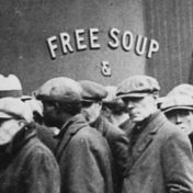 Unemployed men queued outside a depression soup kitchen opened in Chicago by Al Capone