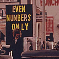 THE STATE OF OREGON WAS THE FIRST TO GO TO A SYSTEM OF ODD AND EVEN NUMBERS DURING THE GASOLINE CRISIS IN THE FALL AND WINTER OF 1973-74. HERE MOTORISTS WITH EVEN NUMBERED LICENSES LINE UP FOR GASOLIN