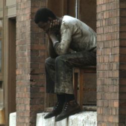 Unemployed Man Sitting on a Windowsil