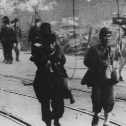 [Survivors moving along the road after the atomic bombing of Nagasaki, Japan.]