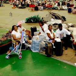 [Hurricane Katrina] Houston, TX, September 15, 2005 -- Kesha Chene, her daughter Destiny, her cousins Sherell, Richard and Kevin Donohue, Esienne and Walter Ramsey wait to move out. The Astrodome is b