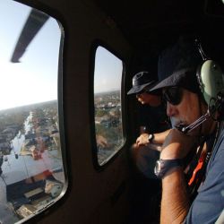 [Hurricane Katrina] New Orleans, LA, September 7, 2005 - FEMA Urban Search and Rescue members look through the windonw of a Blackhawk helicopter to search for residents in areas impacted by Hurricane 