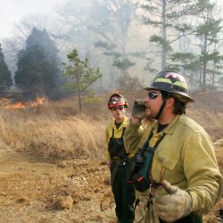 [Severe Wildfire Threat] Mason, OK, January 15, 2006 -- Bureau of Indian Affairs - Chickasaw Agency Crew Boss Tom Schultz and Brady Ward coordinate efforts to control a fire. Bob McMillan/ FEMA Photo