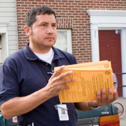 [Severe Storms and Inland and Coastal Flooding] Paterson, NJ, May 5, 2007 -- Community Relations field worker Faustino Salins delivers disaster information to residents in Paterson, N.J. Paterson was 