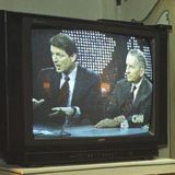 Photograph of President William J. Clinton Watching Vice President Albert Gore and Ross Perot Debate the North American Free Trade Agreement (NAFTA) on Television at the White House