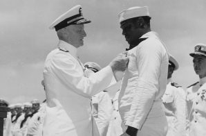 Admiral C. W. Nimitz, CinCPac, pins Navy Cross on Doris Miller, at ceremony on board warship in Pearl Harbor, T. H.