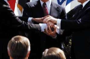 President Jimmy Carter, Egyptian President Anwar Sadat, and Israeli Prime Minister Menachem Begin Join Hands