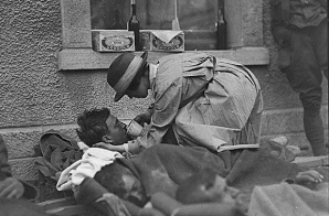 Mrs Hammond, American Red Cross, serving water to wounded British Soldier