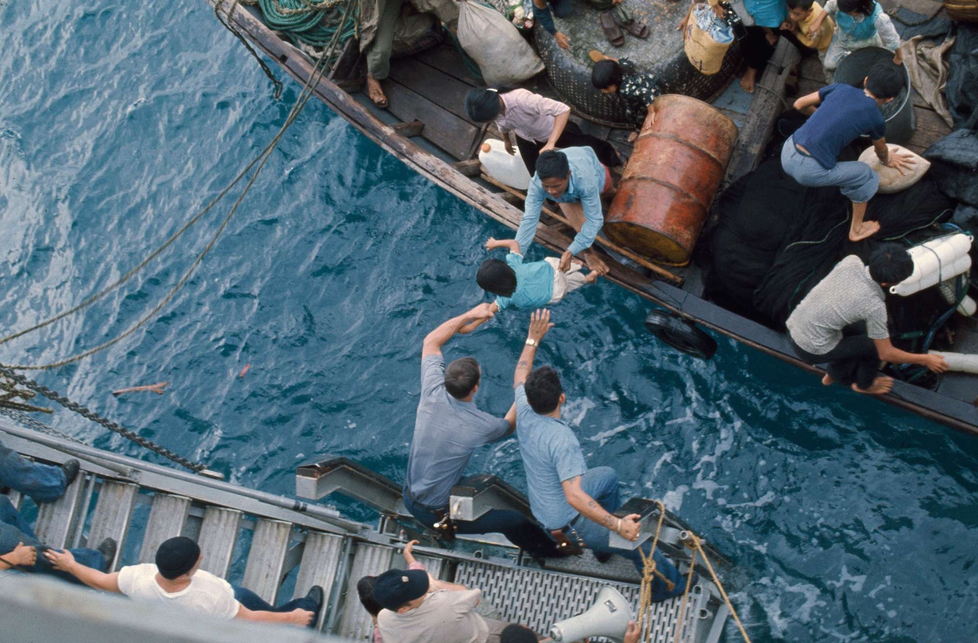 Crewmen Take Vietnamese Refugees Aboard