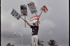 Nixon Supporter Holding Campaign Signs