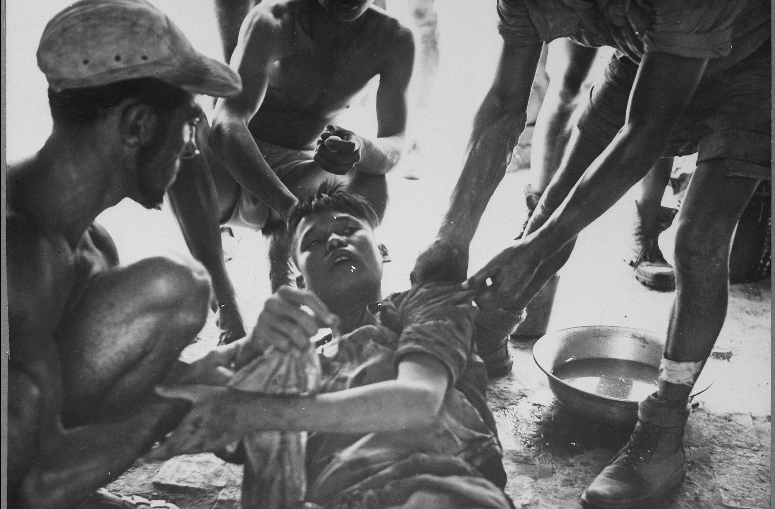Wounded Vietminh Prisoner is Given First Aid
