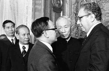 Henry A. Kissinger and Le Duc Tho Shake Hands After Initiating the Vietnam Peace Agreement