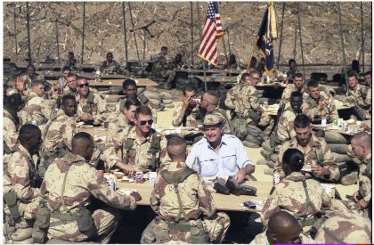 Photograph of President George H. W. Bush Enjoying Thanksgiving Dinner with Troops