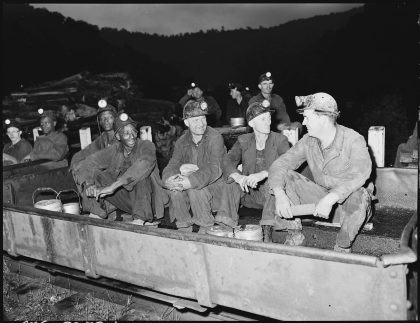 Harry Fain, second from right, seated in shuttle car - Page 01